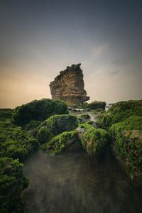 Rock formation amidst rocks against sky