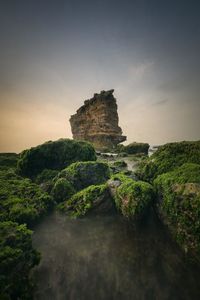 Rock formation amidst rocks against sky