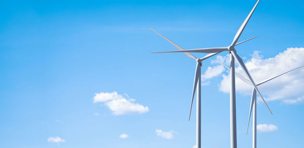 Low angle view of windmill against sky