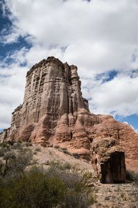 Low angle view of rock formation against sky