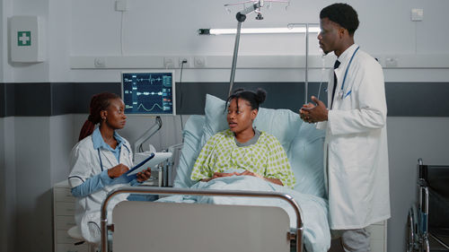 Doctors discussing with patient at hospital