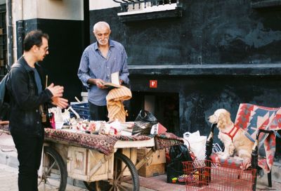 Man looking souvenirs at market stall