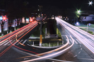 High angle view of light trails on highway at night