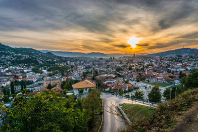 High angle shot of townscape against sky at sunset