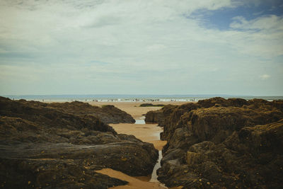 Rocks on beach against sky