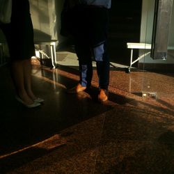 Low section of woman standing on tiled floor