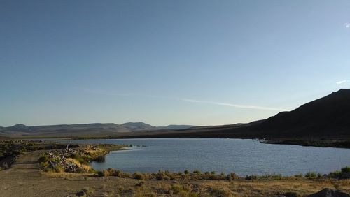 Scenic view of lake against clear blue sky