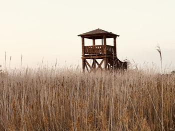 Lifeguard hut on field against clear sky