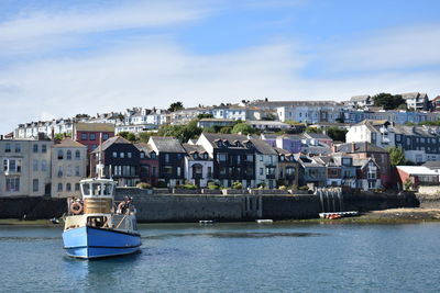 View of townscape by river against sky