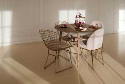 Chairs and table against white wall at home