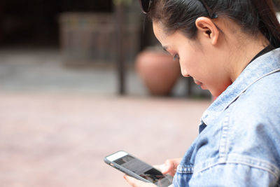 Side view of man using mobile phone