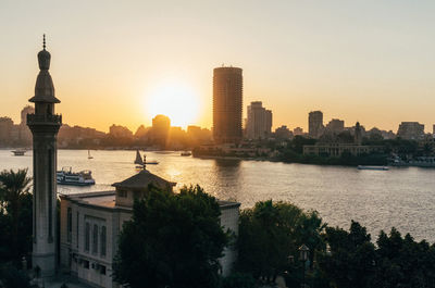 City at waterfront during sunset