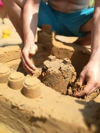 Close-up of hands on sand