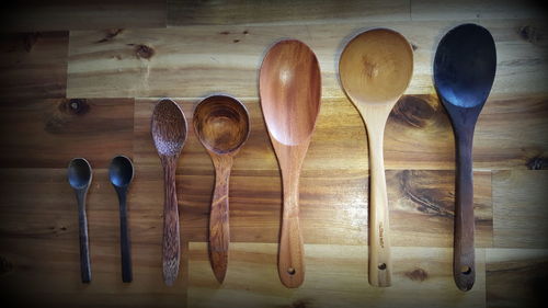 Directly above shot of various wooden spoons on table