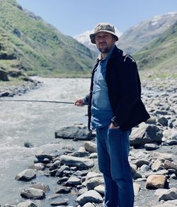 Portrait of man fishing at river