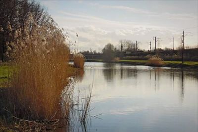 Scenic view of lake against cloudy sky