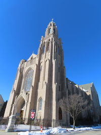 Low angle view of historic building against clear blue sky