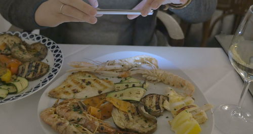 High angle view of person preparing food on table