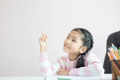 Portrait of a girl sitting on table