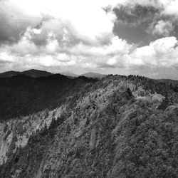 Scenic view of mountains against cloudy sky