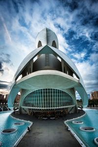 Low angle view of modern building against cloudy sky