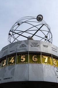 Low angle view of text on building against sky