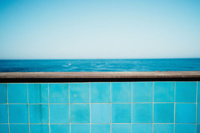 Blue tile railings against sea