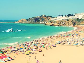 High angle view of people on beach against clear sky