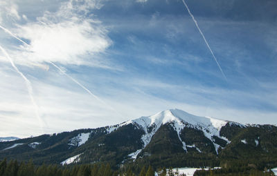 Low angle view of snowcapped mountains against sky