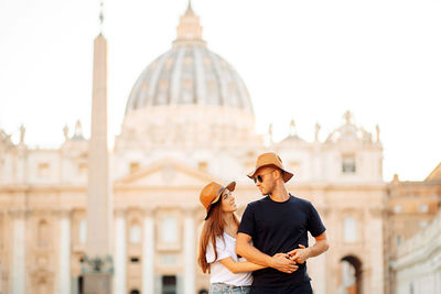 A young happy couple travels in italy, walks in rome. portrait of young friends. tourism, travel