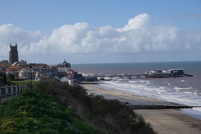 Scenic view of sea and buildings against sky