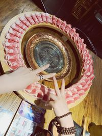 High angle view of woman preparing food on table