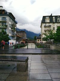 Buildings against cloudy sky