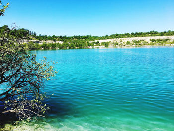 Scenic view of lake against clear blue sky