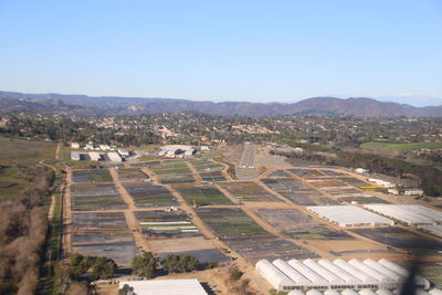 Aerial view of agricultural field against clear sky