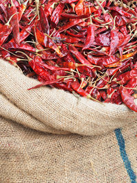 High angle view of dried red chili pepper in sack at market