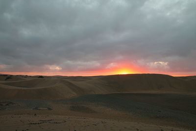 Scenic view of landscape against cloudy sky