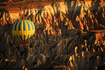 View of hot air balloon flying over rocks