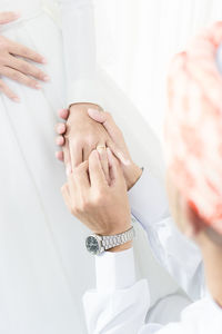 Midsection of couple holding hands