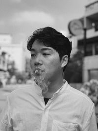 Portrait of young man looking away outdoors