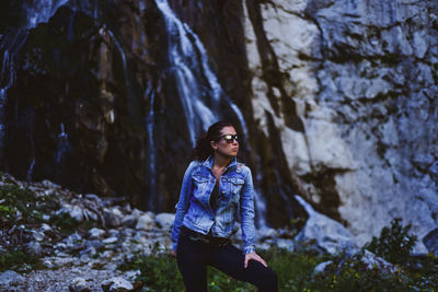 Young woman standing on rock