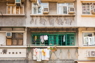 Sheung wan,  hong kong, china, asia - housing project apartments with clothelines on the window.