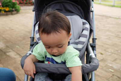 Close-up of boy sitting outdoors