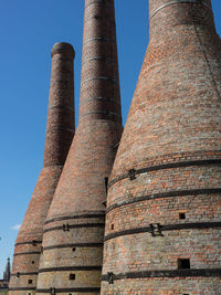 Low angle view of smoke stack against clear sky