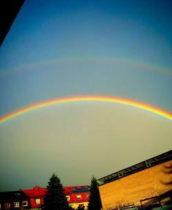 Low angle view of rainbow over buildings