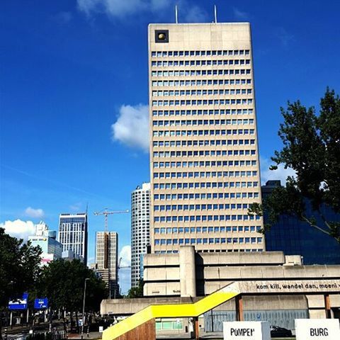 building exterior, architecture, built structure, city, modern, low angle view, office building, skyscraper, tall - high, sky, tree, building, tower, blue, city life, street light, cloud, tall, day, glass - material