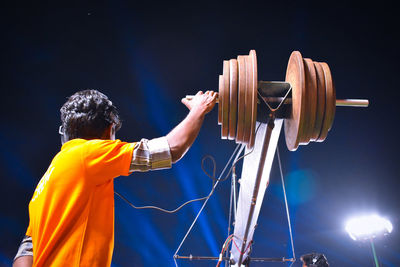 Rear view of man playing against the sky