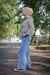 Rear view of woman standing on road