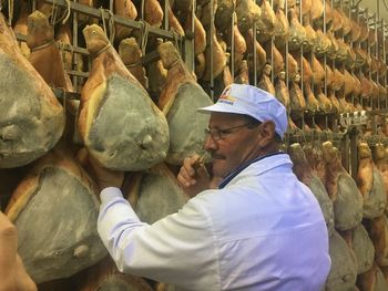 Side view of man working at store