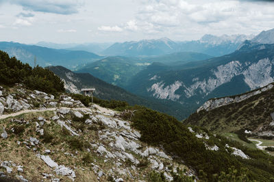 Scenic view of valley and mountains against sky